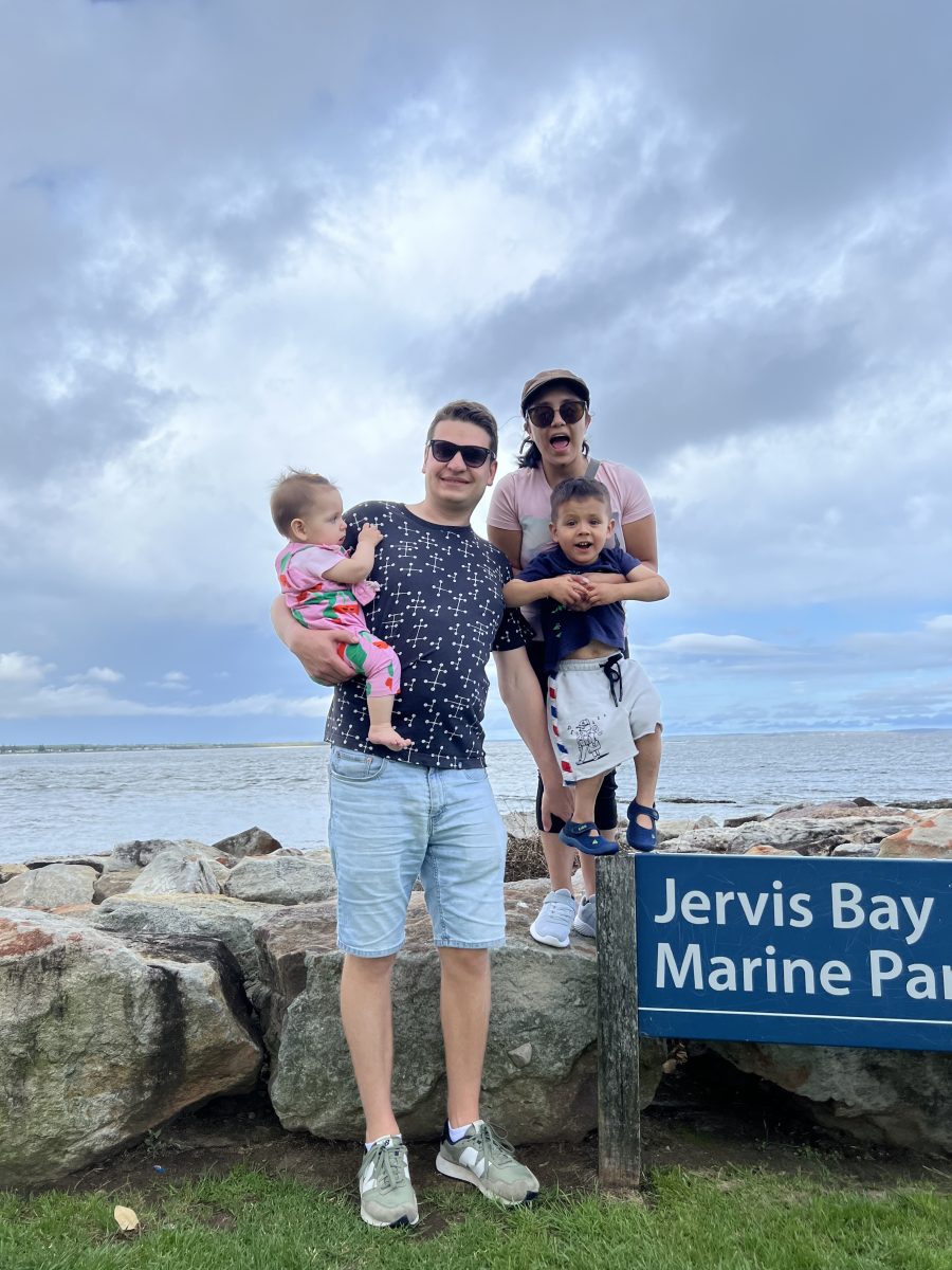 Man and woman holding two kids at Jervis Bay