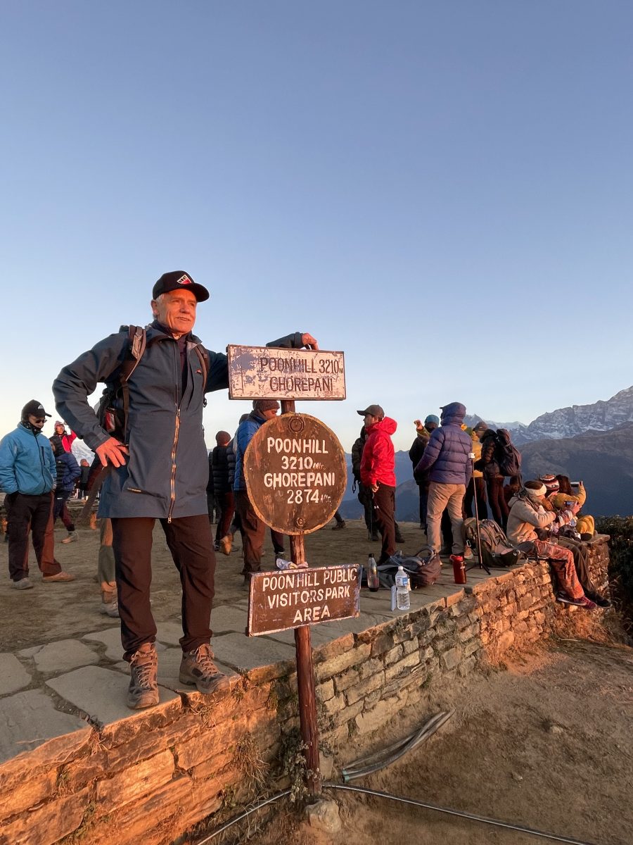 man standing next to sign in Nepal