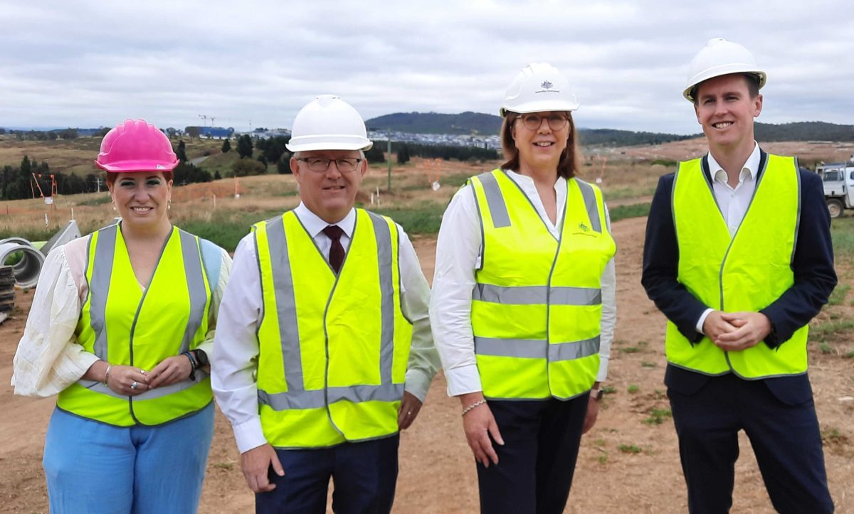 four people in hi-viz and hard hats