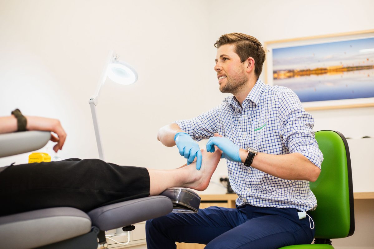 man massaging feet