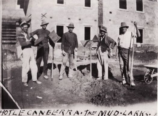 Five men on building site with spades