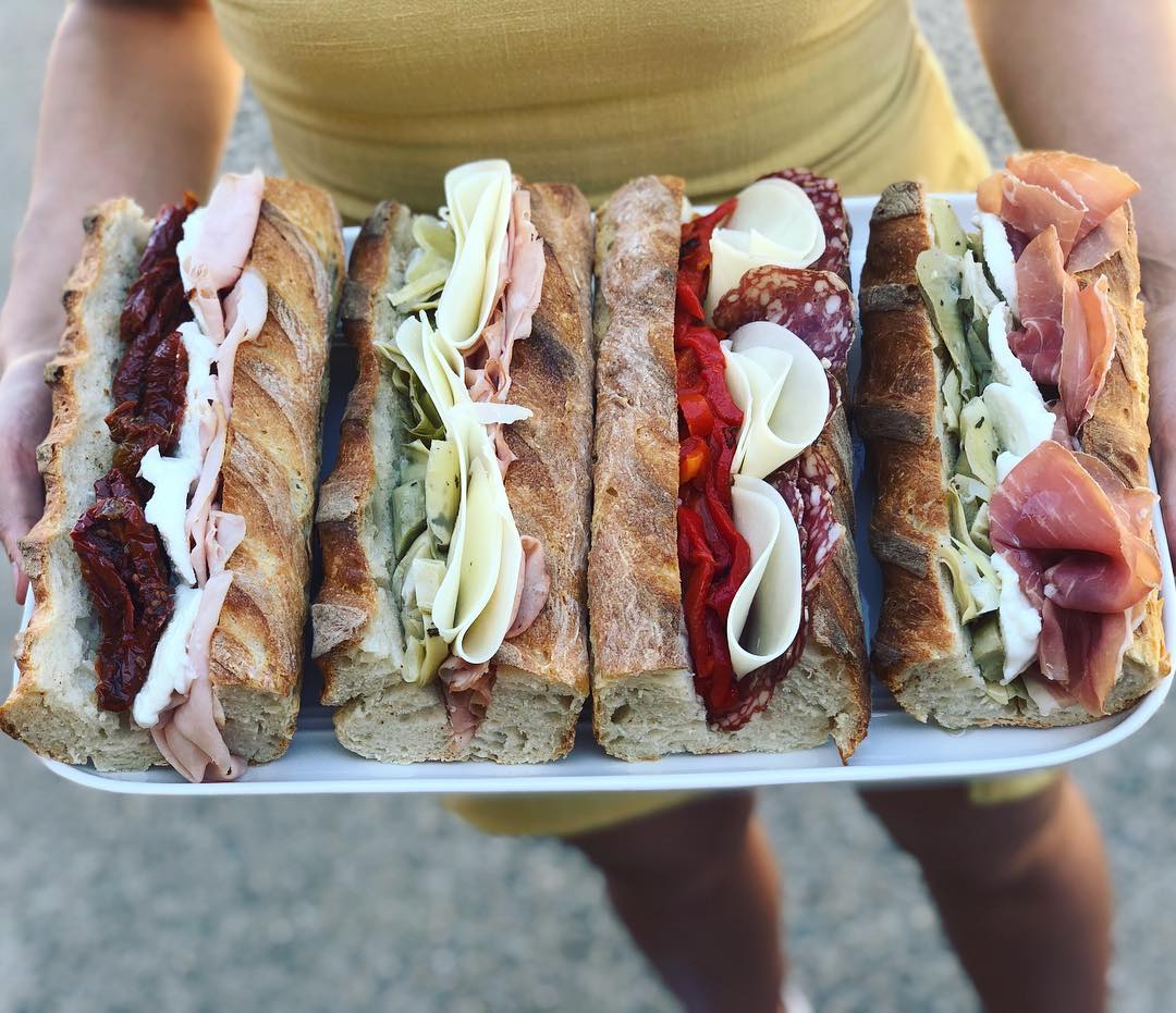 Four delicious looking panini with deli fillings.