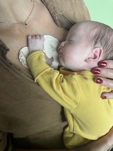 Breastfeeding baby with "heart" 