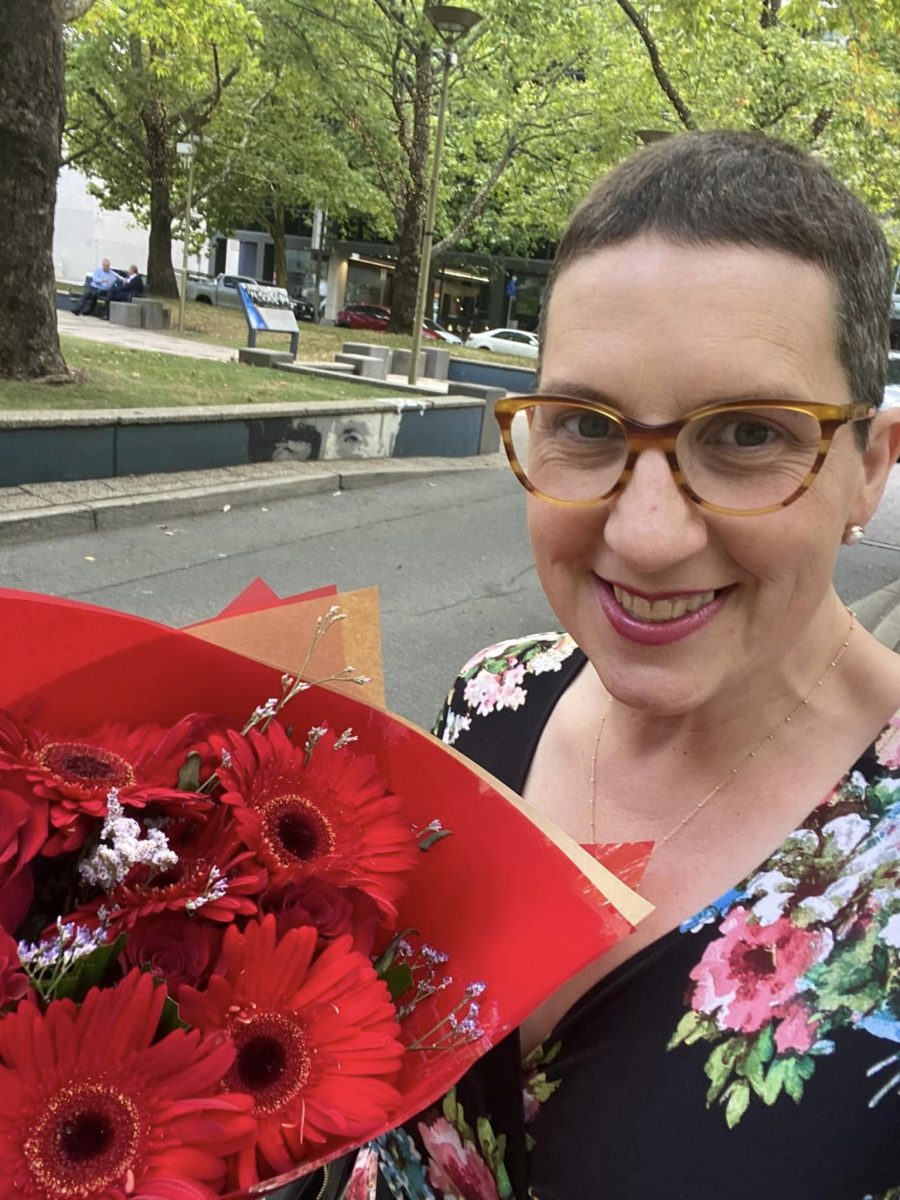 Woman with bouquet of red flowers