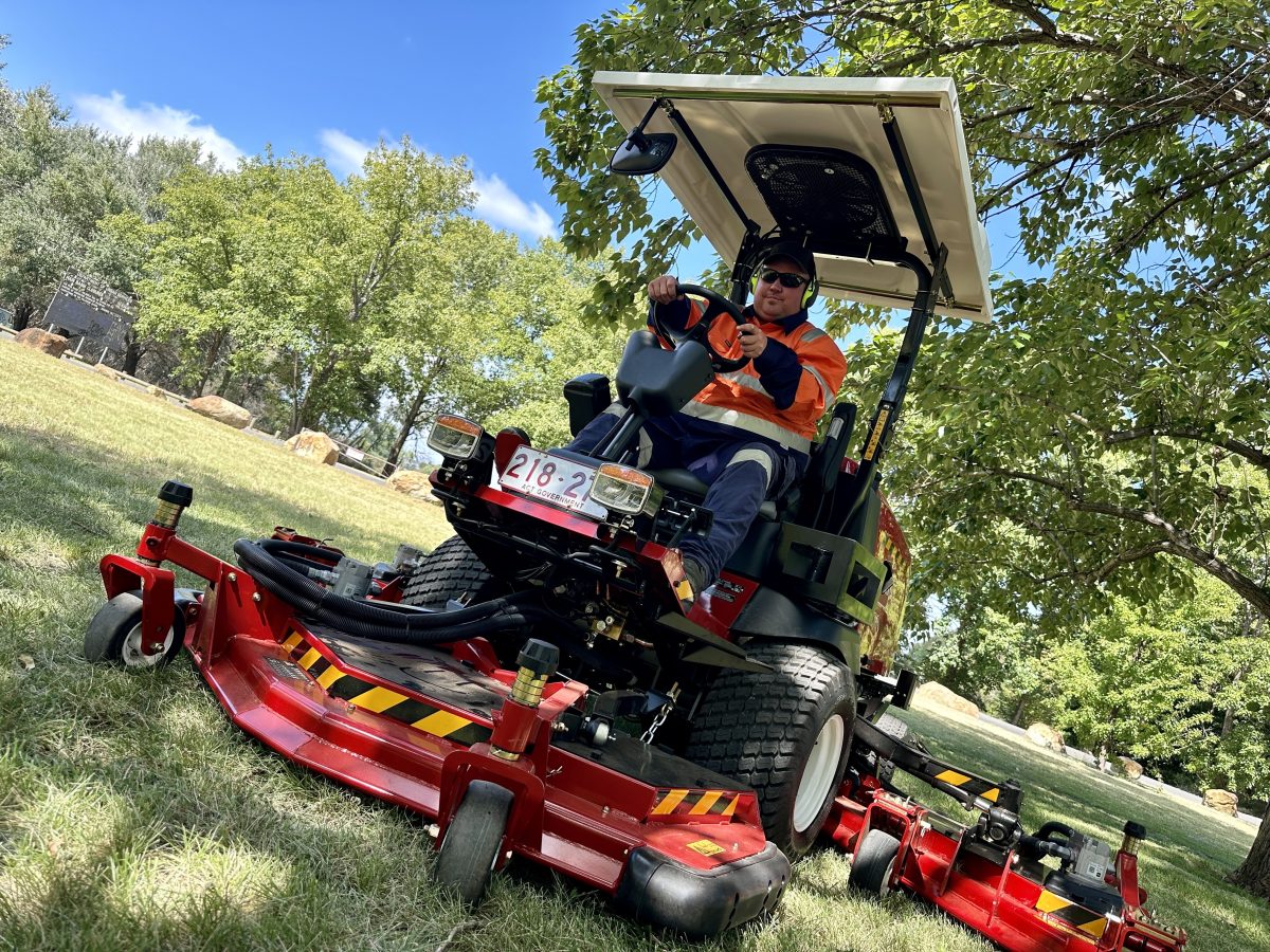 man driving a mower