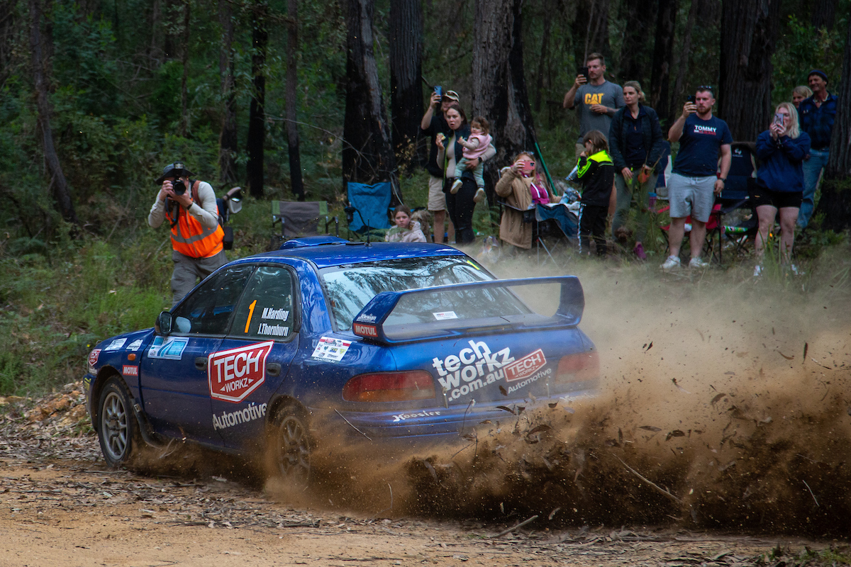 People watching a rally car