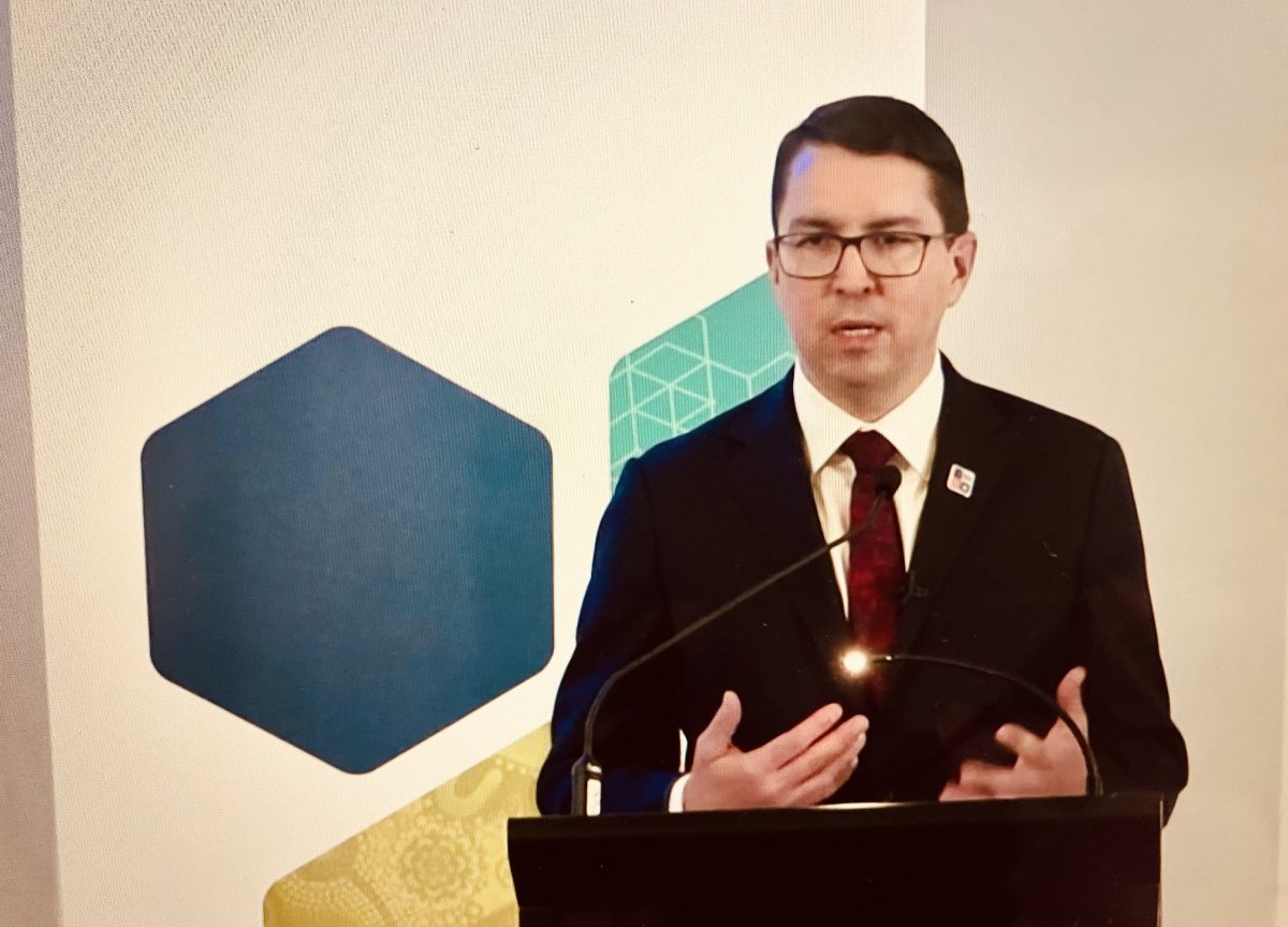 man speaking at a lectern