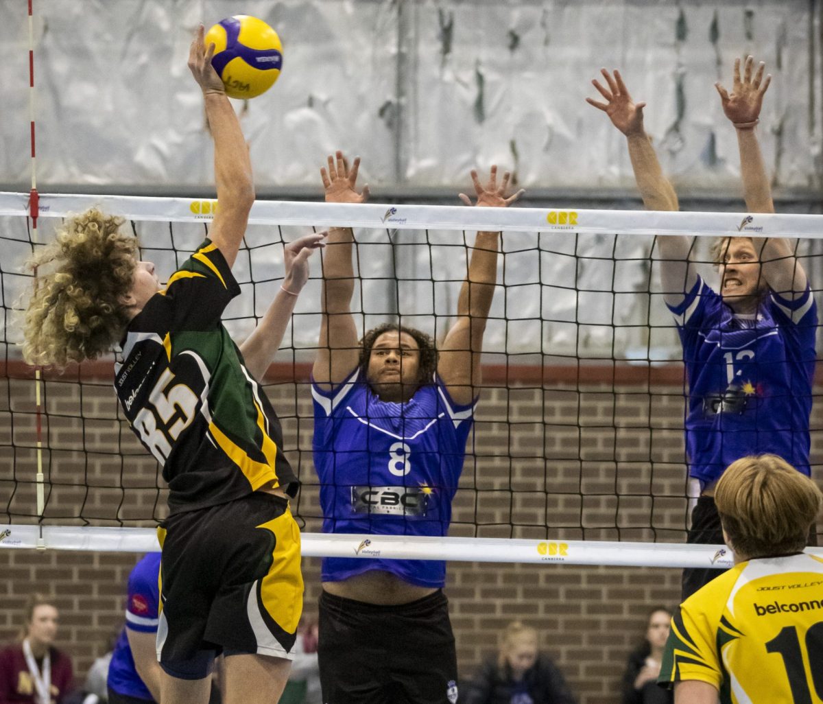 People play indoor volleyball