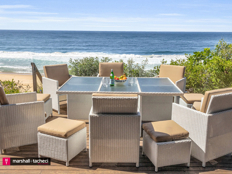 table and chairs on beachside deck