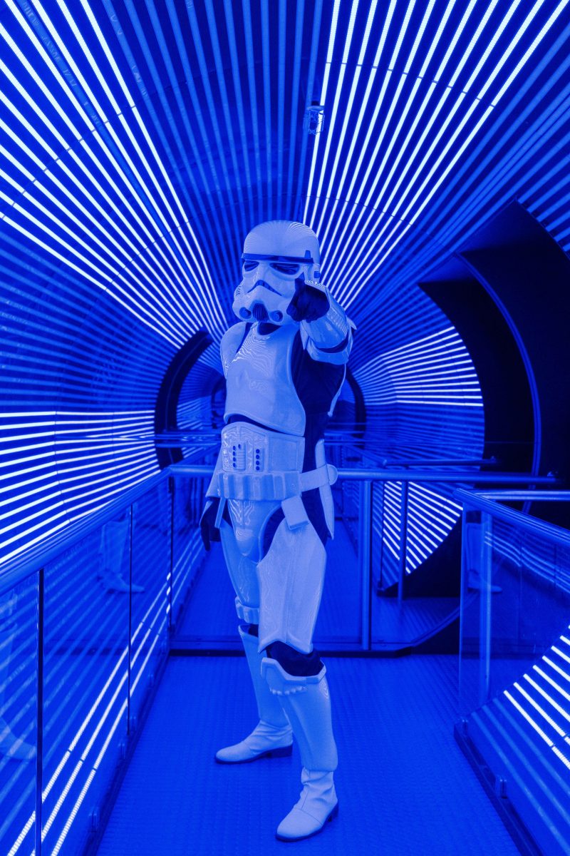 A person in a Stormtrooper costume standing in a lit tunnel