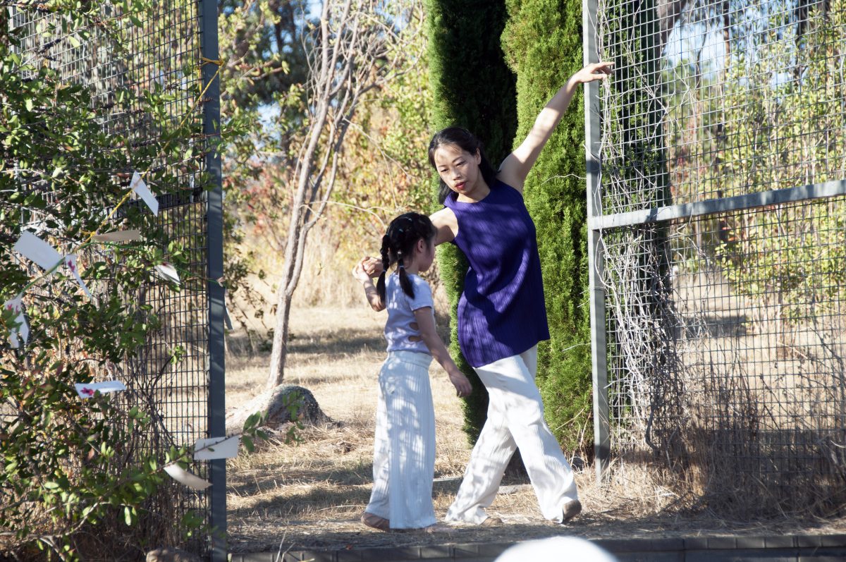 woman dancing in garden with child