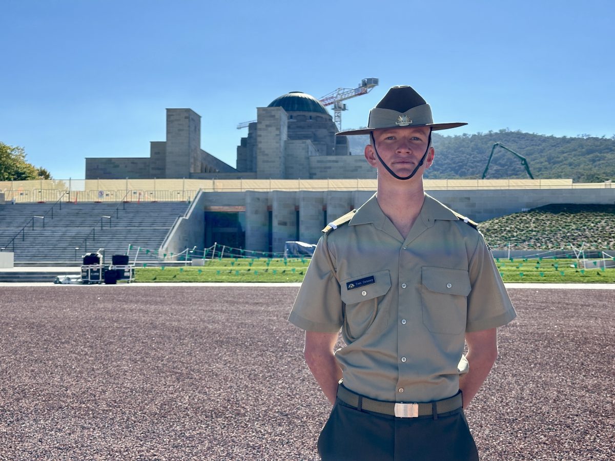 Cadet standing in front of the War Memorial