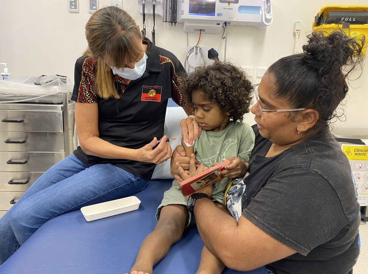 Indigenous family receiving flu shot