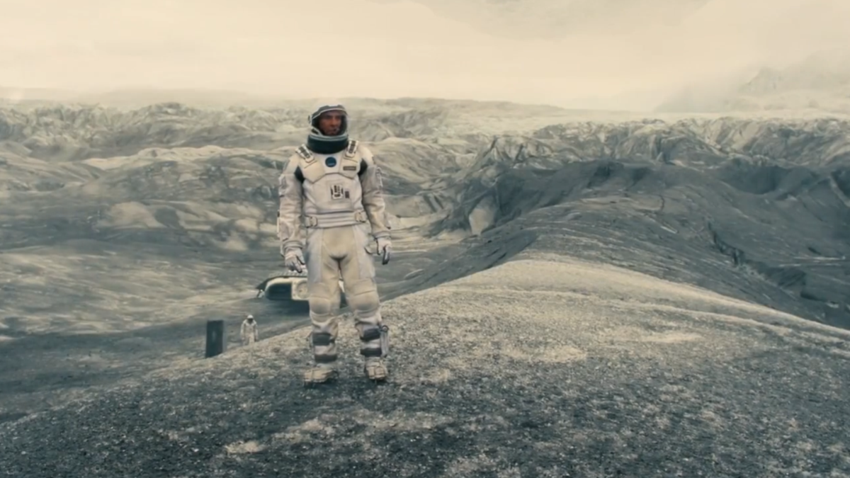 Still from Interstellar showing a person in a space suit in a desolate landscape