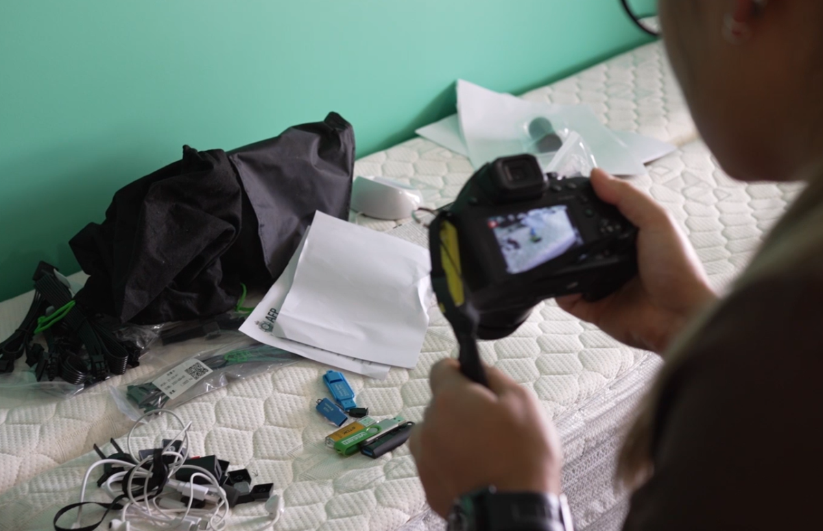 person photographing electronic devices