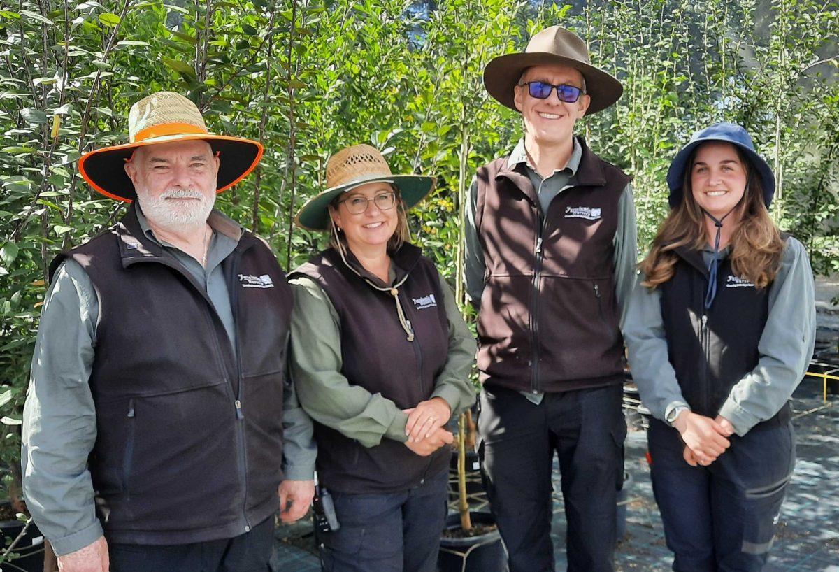 four people standing in a nursery