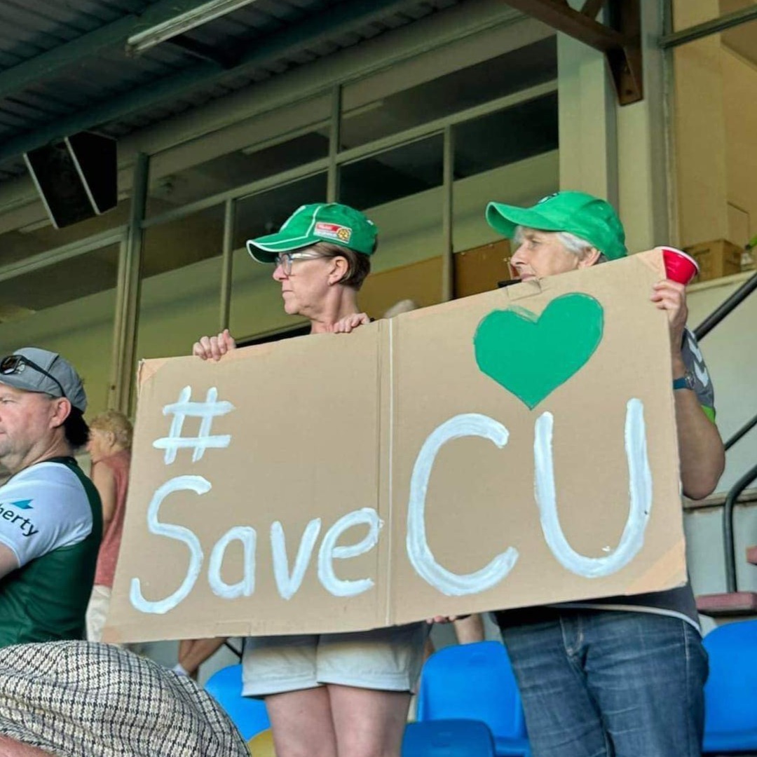 women holding Save CU sign