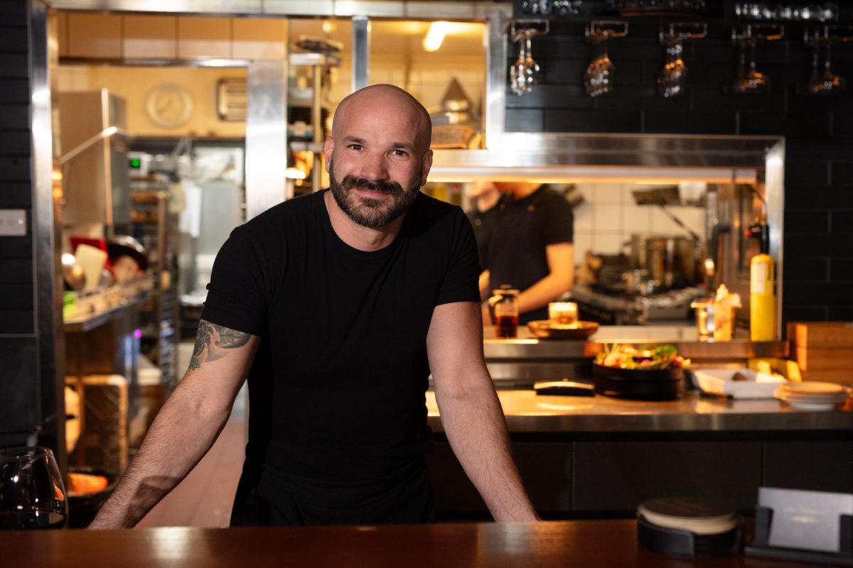 A man leaning on at table