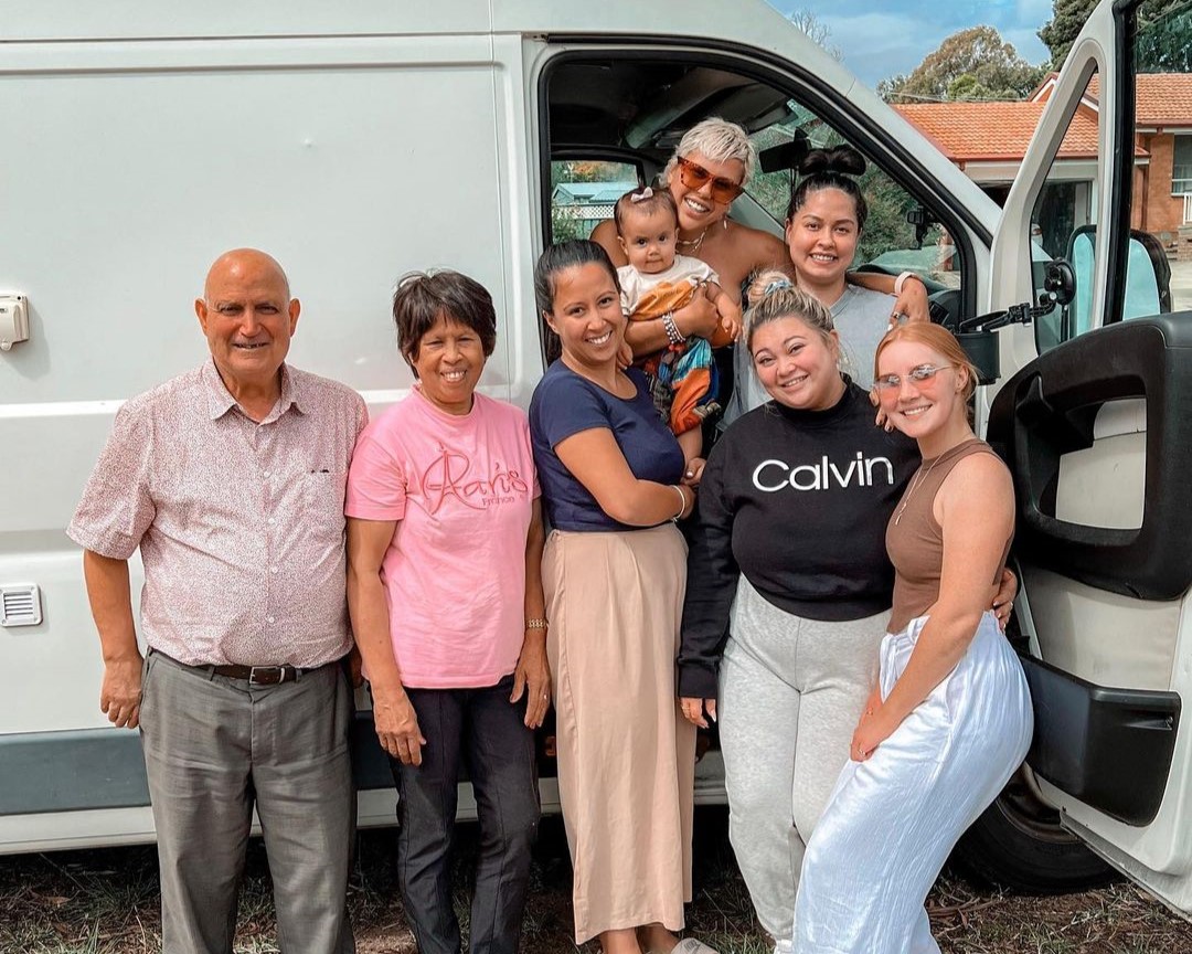 family standing next to a van
