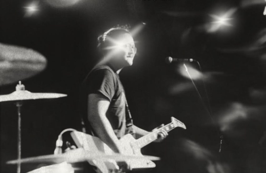 man with guitar on stage