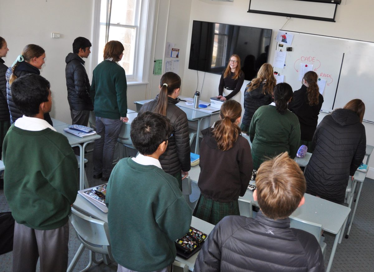 children standing in a classroom