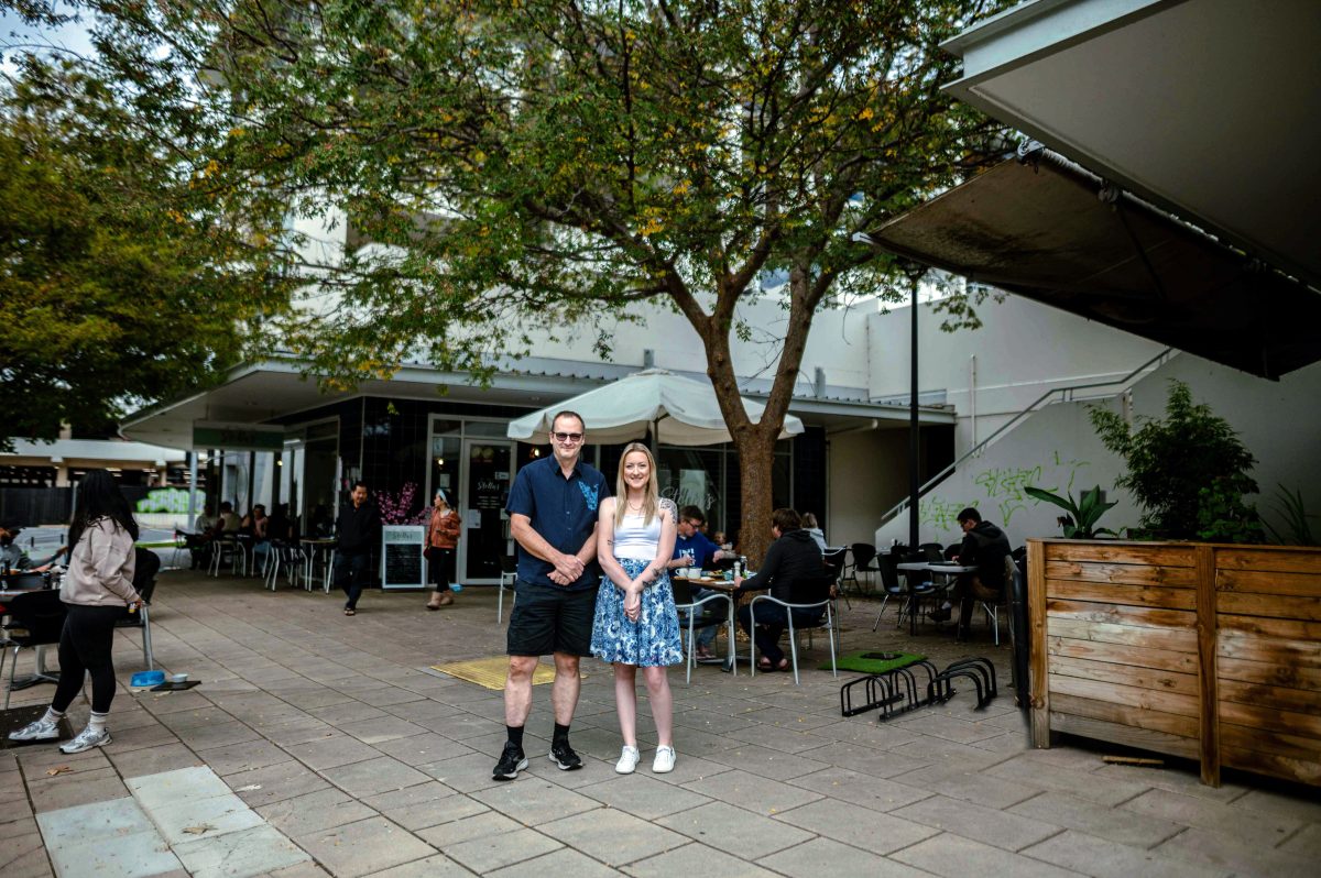 man and woman outside a cafe