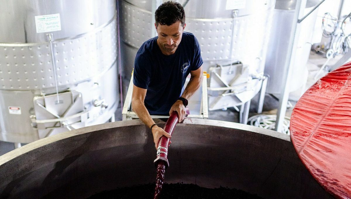 Man pouring large amount of wine