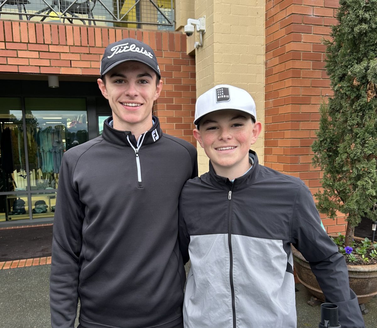 two young men outside golf clubhouse