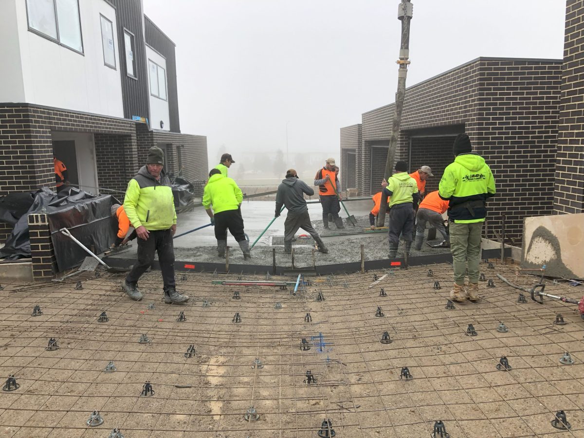 Men walk around a building site