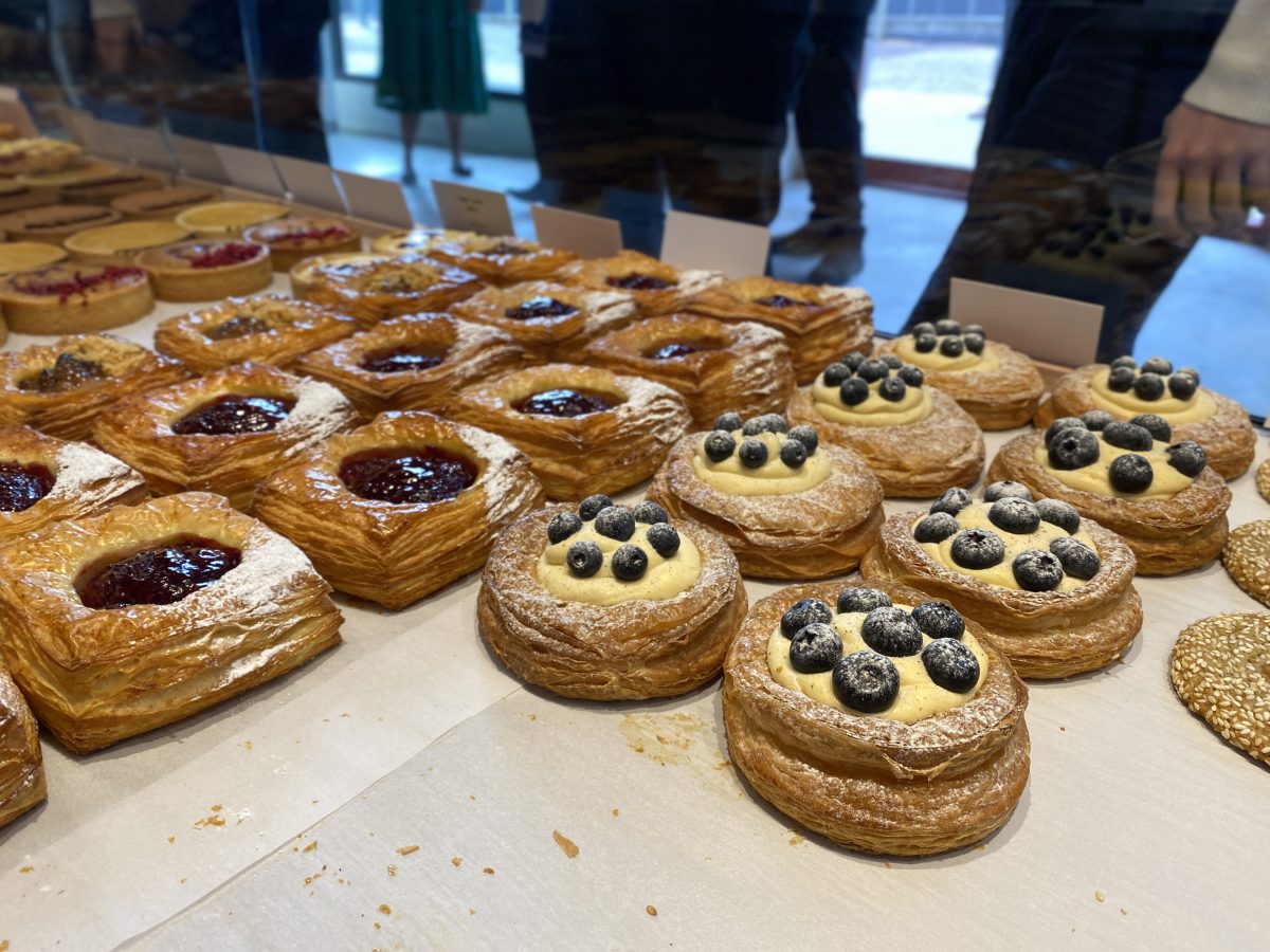 Danishes topped with blueberries and icing sugar.