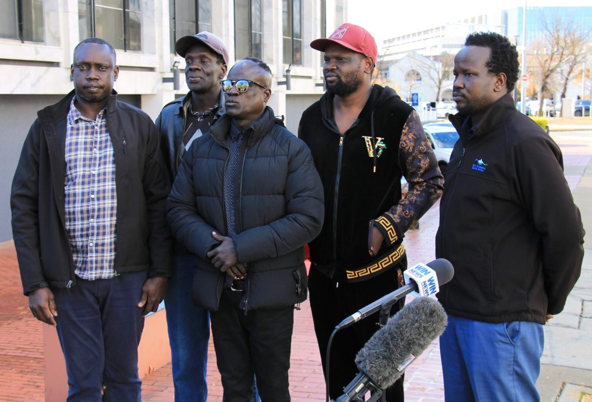 five men at a press conference