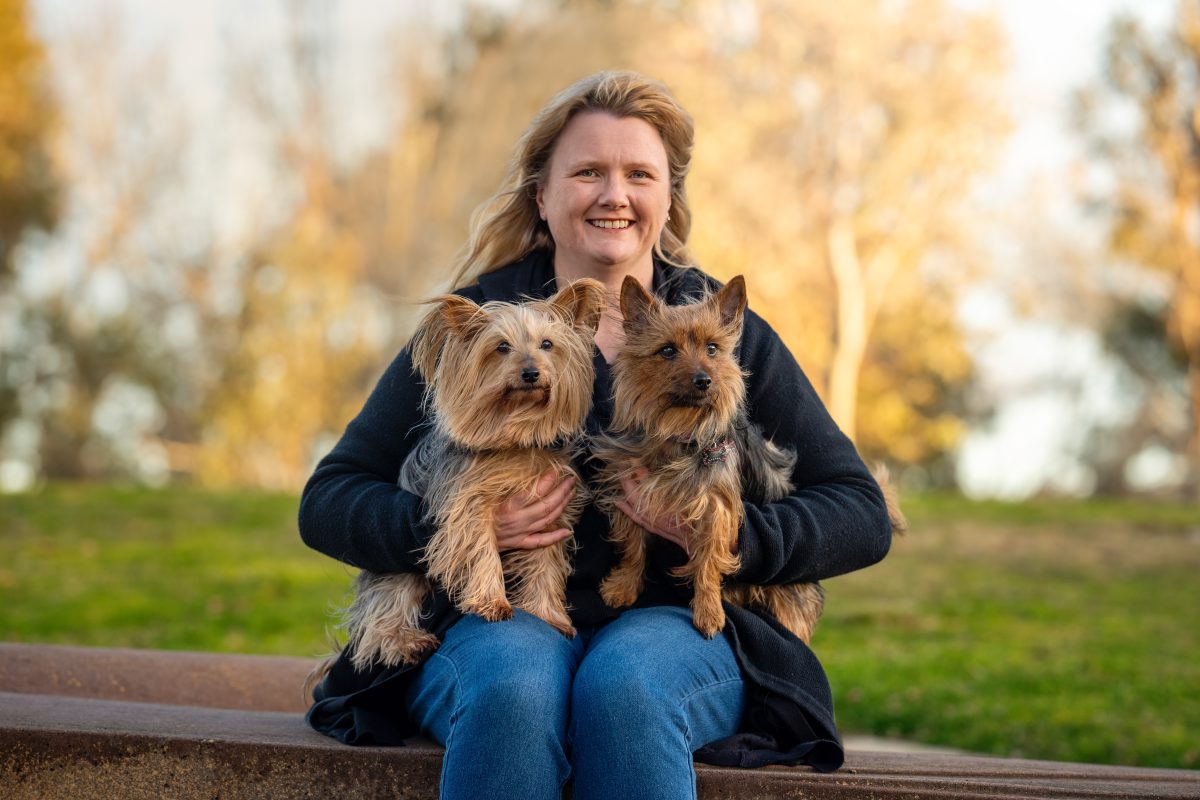 woman holding two dogs