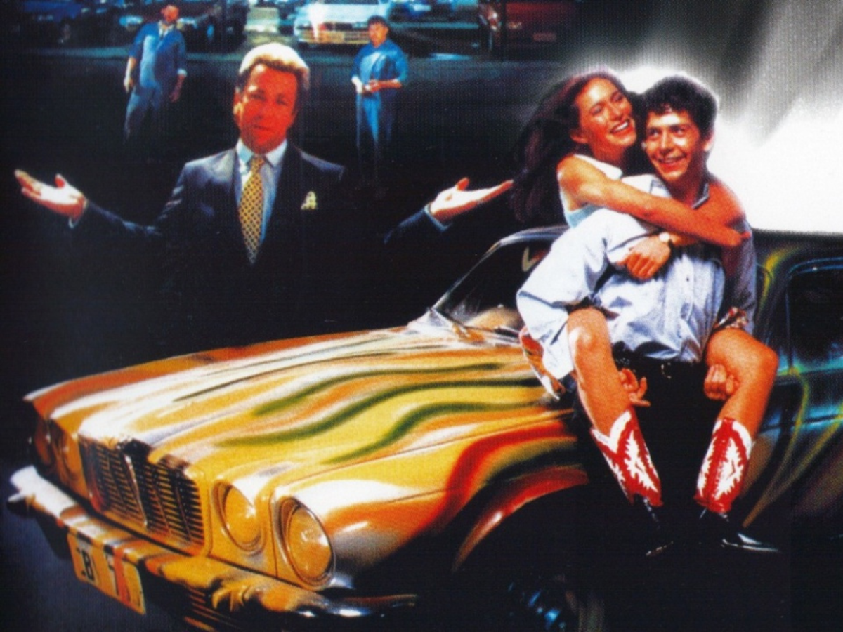 Stylised composite image from The Big Steal showing a man holding a woman in front of a car, with a man in a suit behind it holding his hands out and shrugging