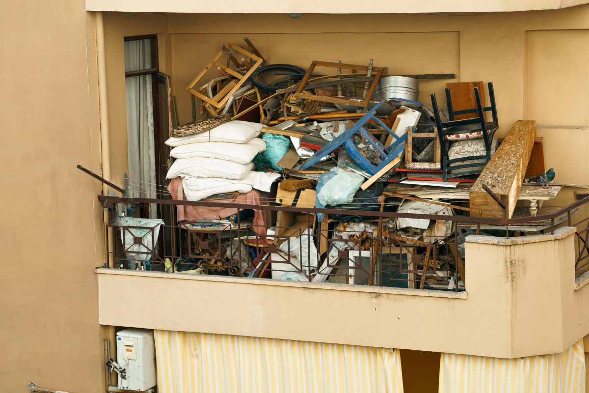 Balcony full of garbage, old furniture and clutter