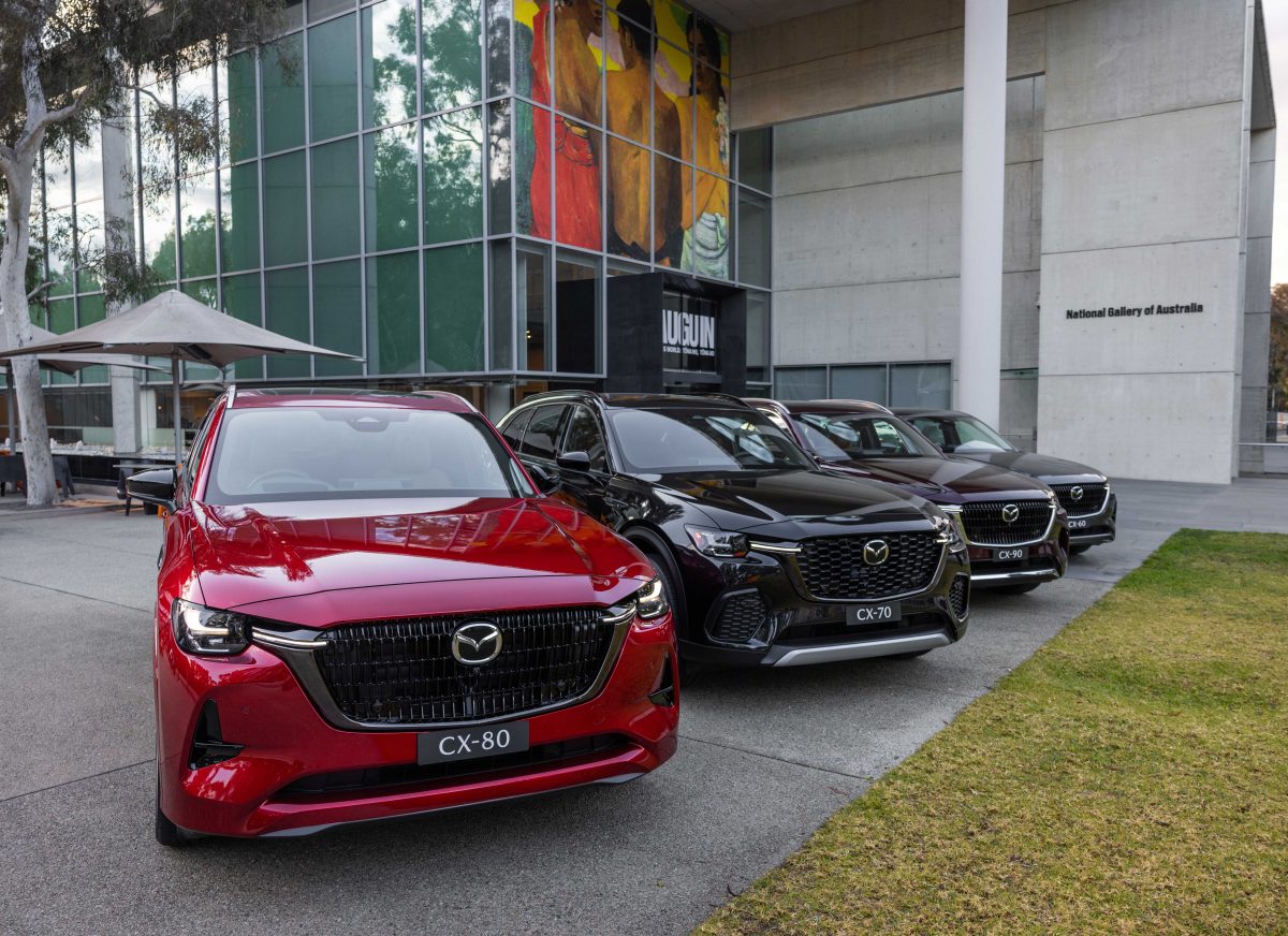four new SUVs on display outside a gallery