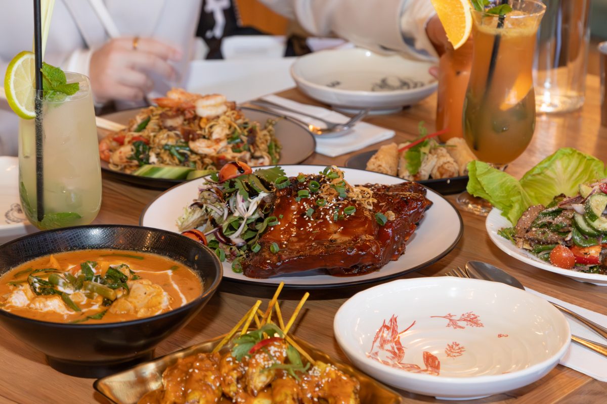 A photo of food, ribs, chicken skewers and curry from Kinn Thai