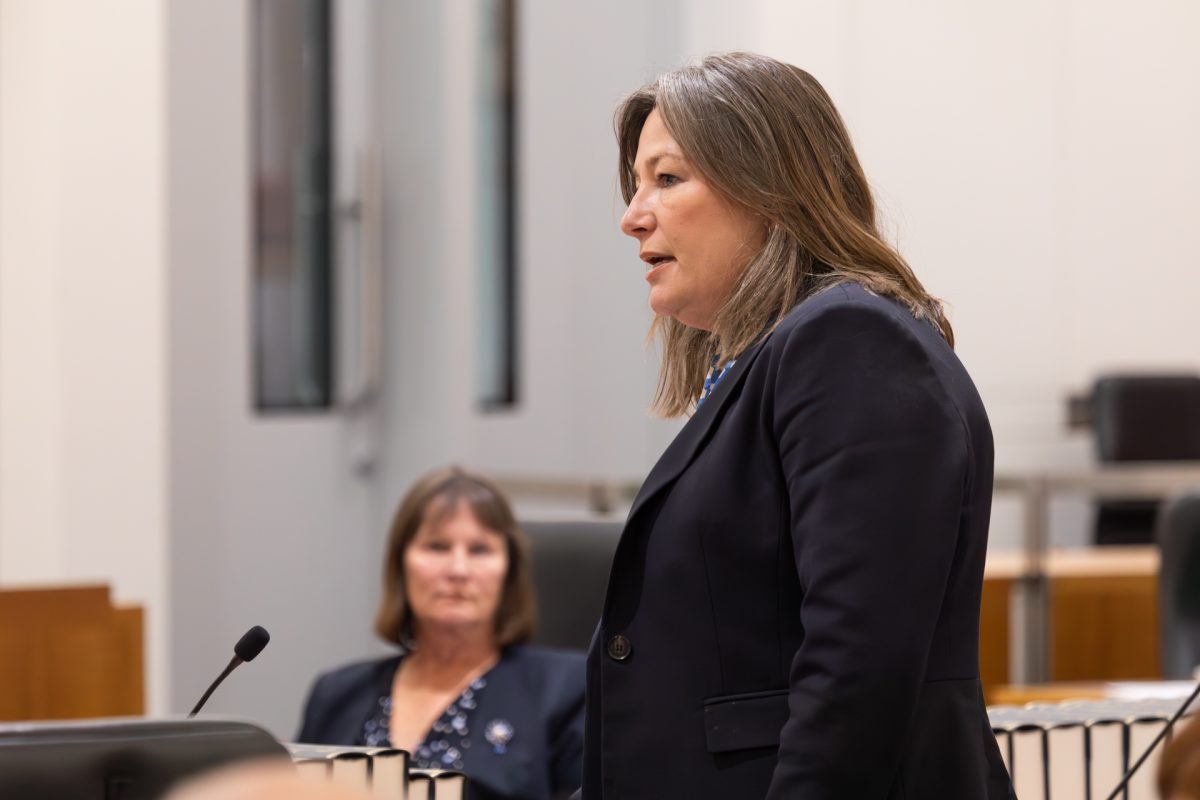 Woman speaking into microphone