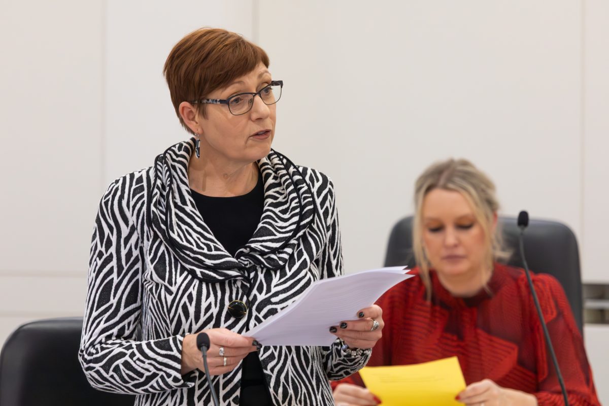 Woman speaking into microphone