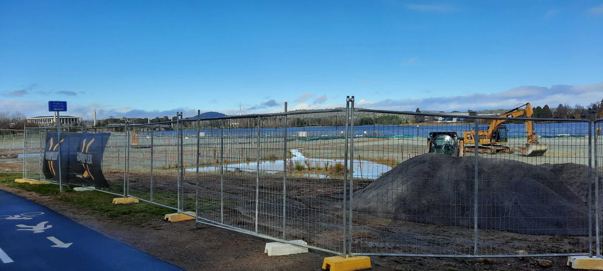 fenced-off park under construction