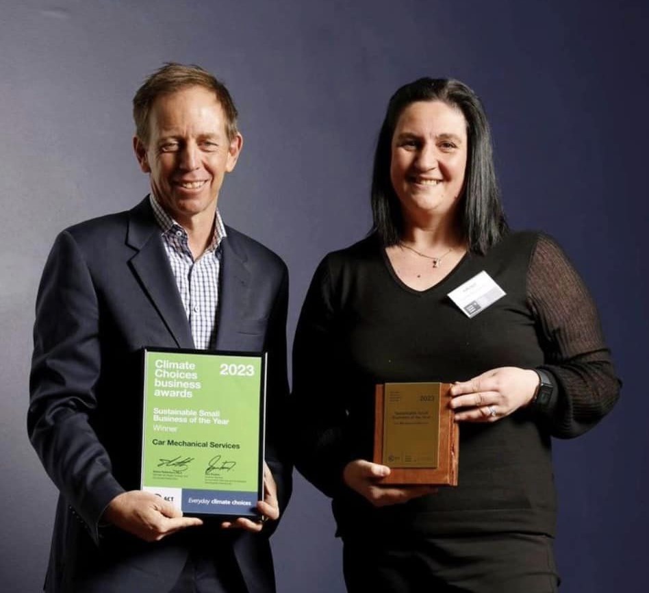 woman reciving award from Shane Rattenbury