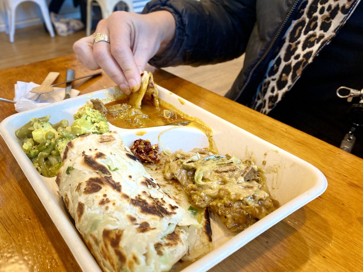 Roti with curries in takeaway container.