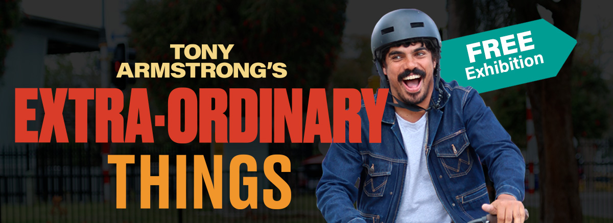 Tony Armstrong's Extra-Ordinary Things. Free Exhibition. Tony smiling on a bike.