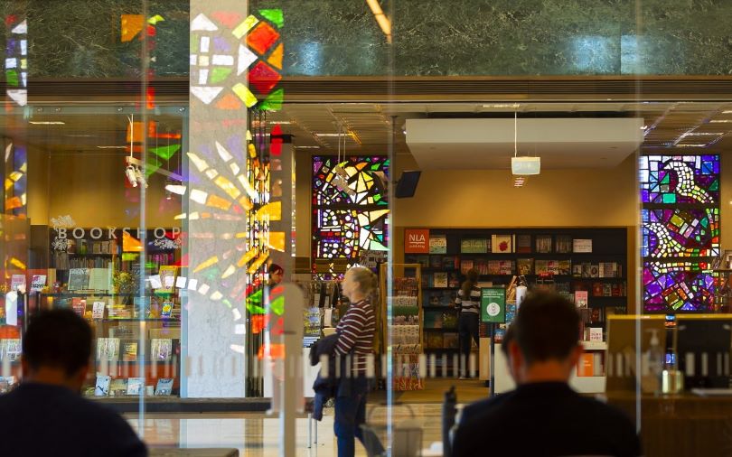 A photo of the front of the National Library of Australia bookshop capturing some visitors of the Library.