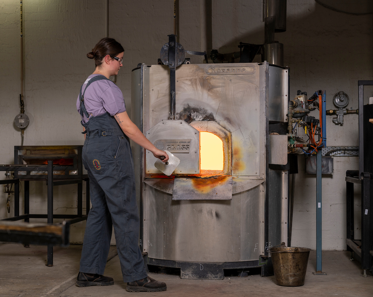 Woman at glass blowing furnace