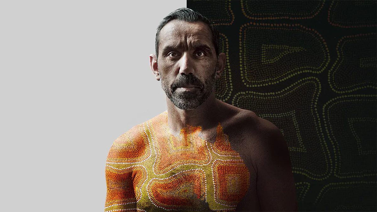 Promotional still for The Australian Dream showing a man with a dot painting of a map of Australia on his chest
