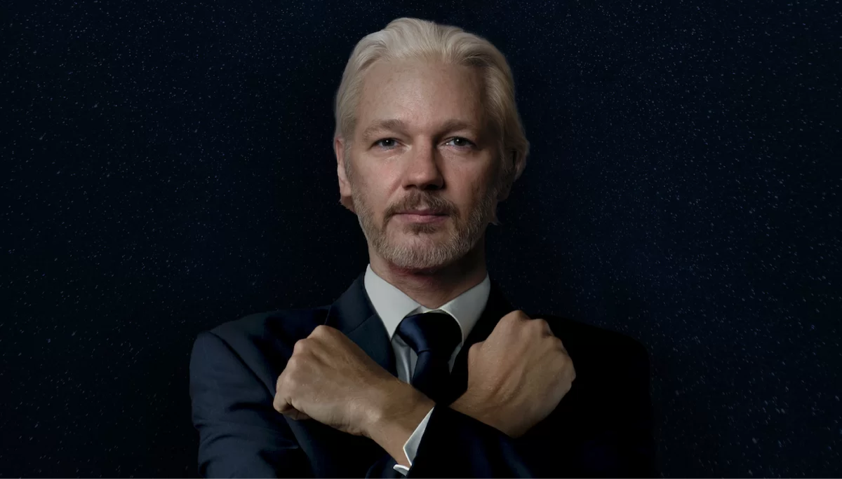 Promotional image for The Trust Fall, showing Julian Assange with arms crossed over his chest