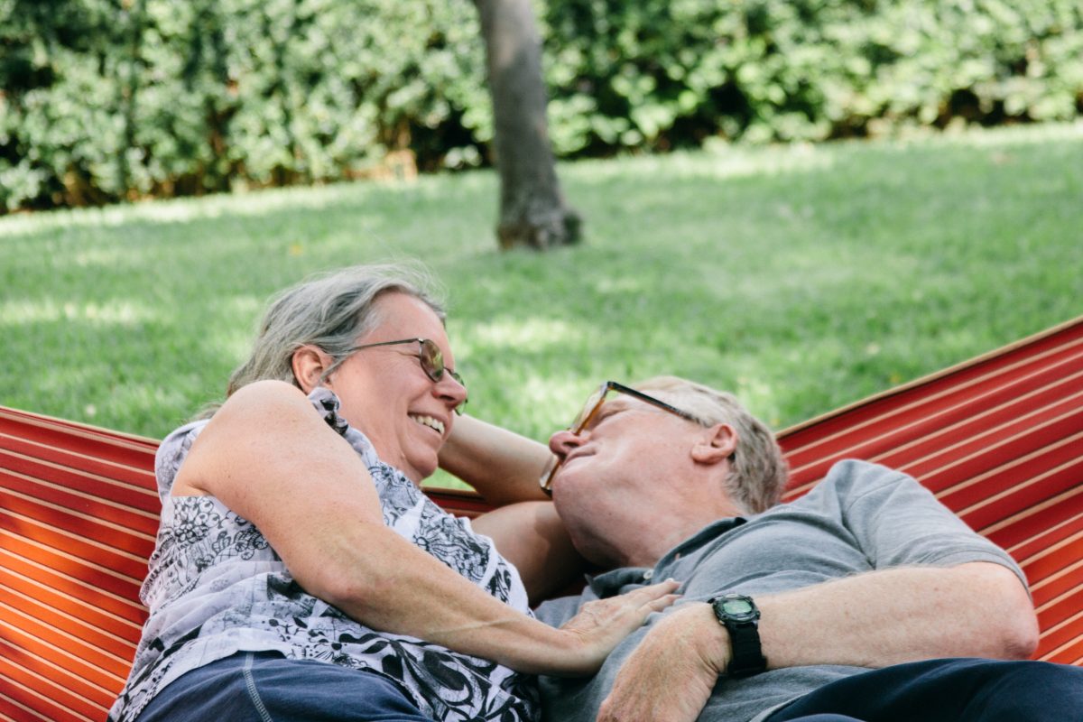Retired couple relax in a hammock
