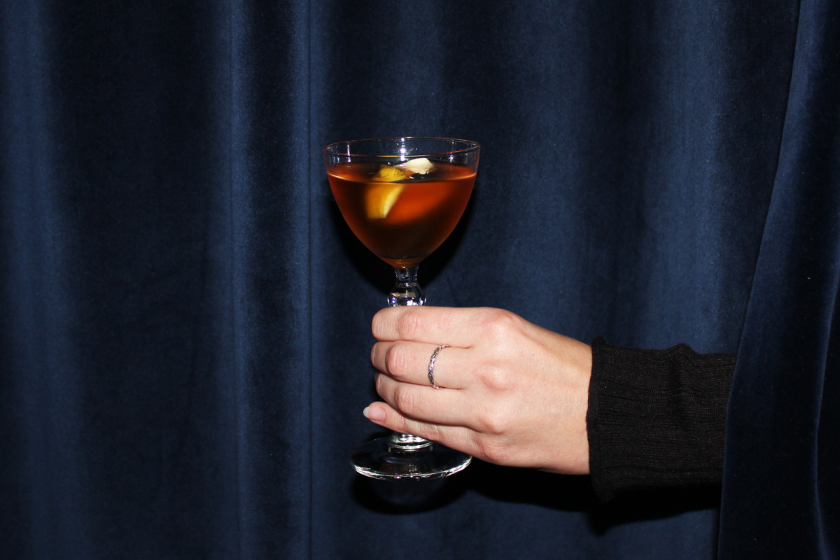 a hand holding a cocktail glass