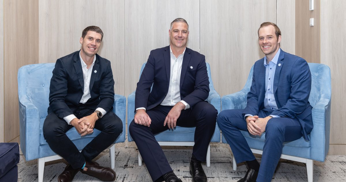 Three men sitting on chairs