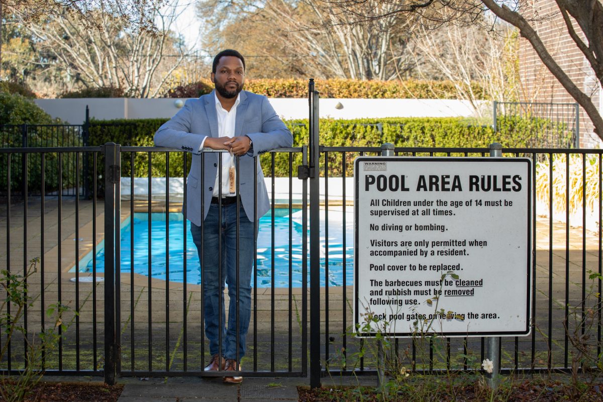 Man leaning on pool fence